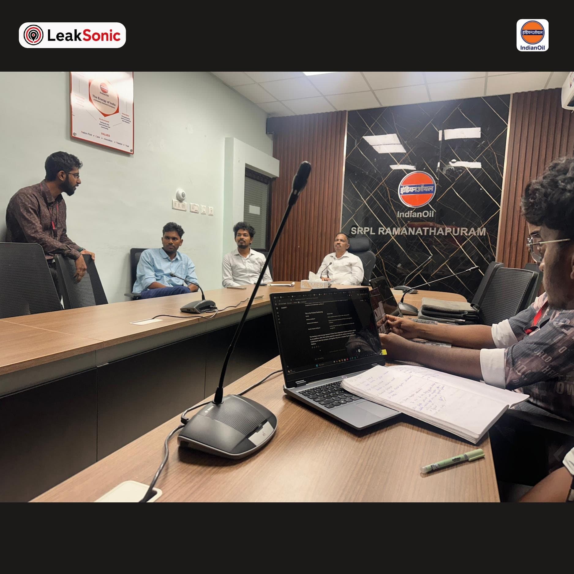 The LeakSonic team seated at the conference table inside Indian Oil Corporation's SRPL Ramanathapuram office, beneath the IndianOil and SRPL Ramanathapuram signage