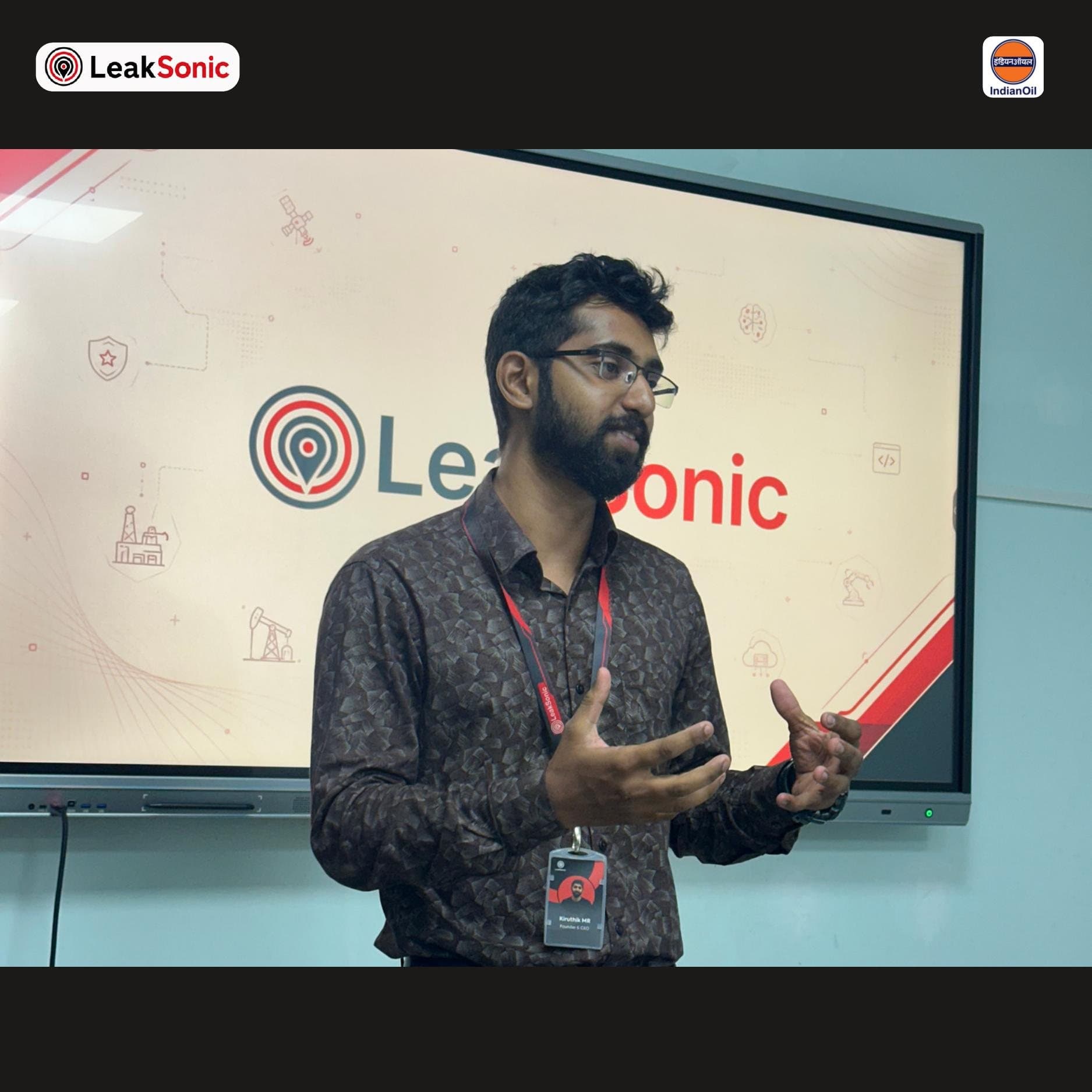 Kiruthik M R, Founder and CEO of LeakSonic, presenting in front of the Sentrix branding screen at IOCL SRPL Ramanathapuram, wearing a name badge reading Kiruthik MR, Founder and CEO